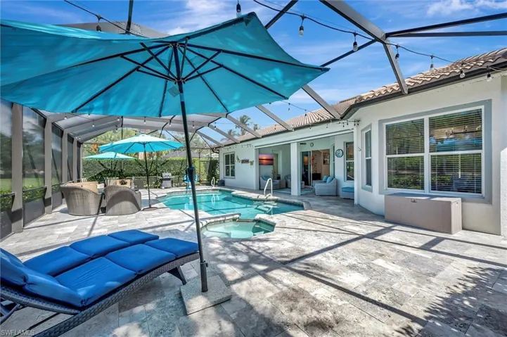 View of pool with a sunroom, glass enclosure, and a patio