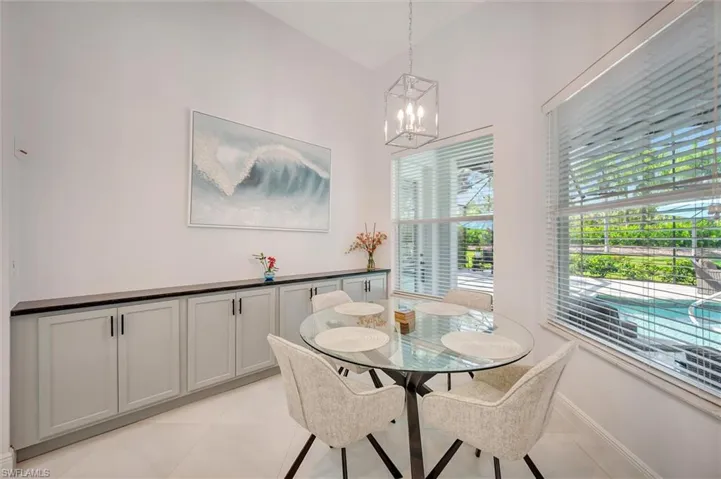 Dining space featuring light tile patterned floors and a chandelier