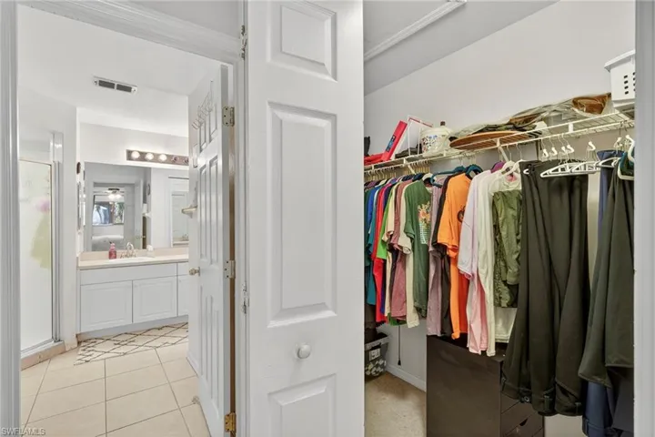 Walk in closet with light tile patterned flooring and a sink