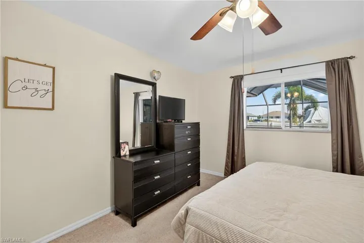 Bedroom with light carpet and ceiling fan