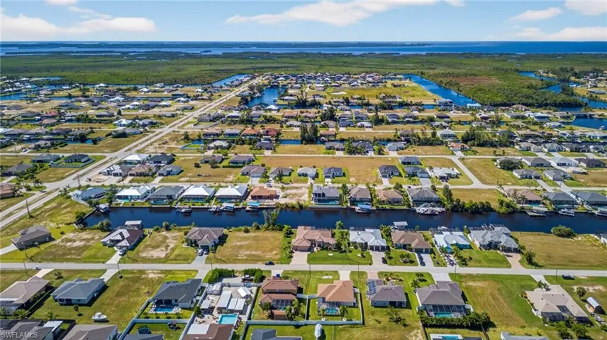 Aerial overview of property's location with a nearby body of water and nearby suburban area