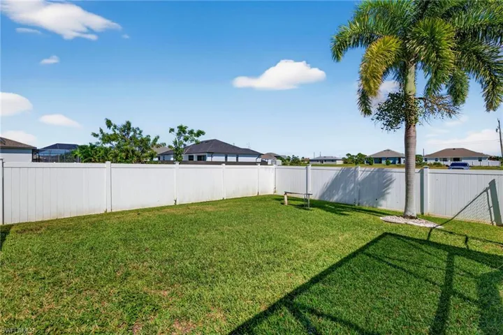 Fenced backyard with a residential view
