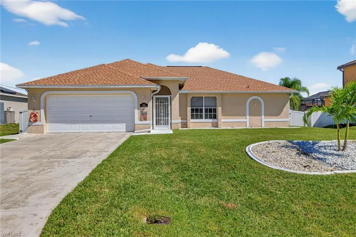 Mediterranean / spanish-style home featuring stucco siding, concrete driveway, an attached garage, and roof with shingles