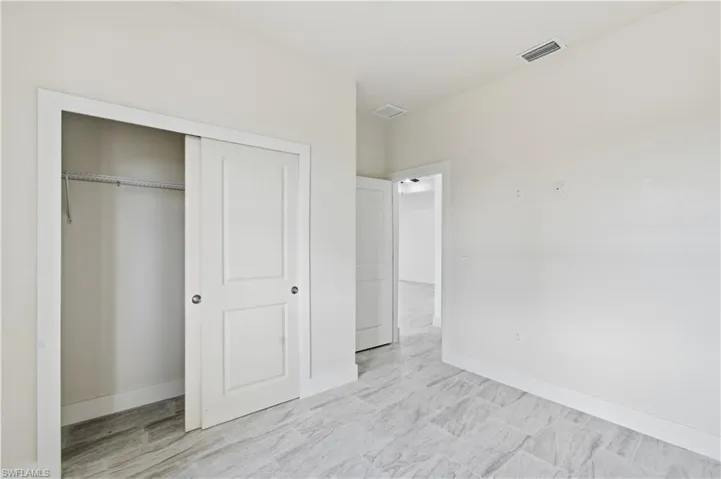 Unfurnished bedroom with a closet and baseboards