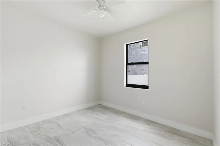 Unfurnished room featuring baseboards and ceiling fan
