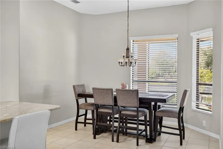 Dedicated dining area with chandelier and light tile flooring. Great for family meals and entertaining.