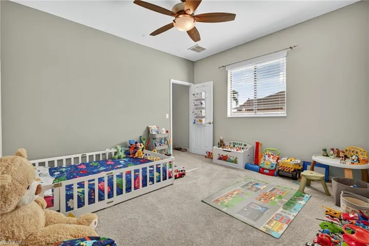 room with ceiling fan. Ideal as a game room, playroom, or media space.