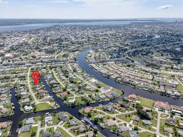 Birds eye view of property with a water view