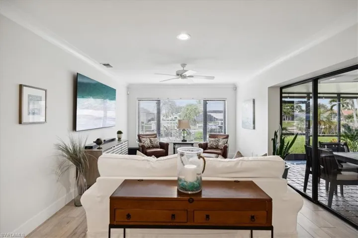Living room featuring Water Views, Crown molding and ceiling fan