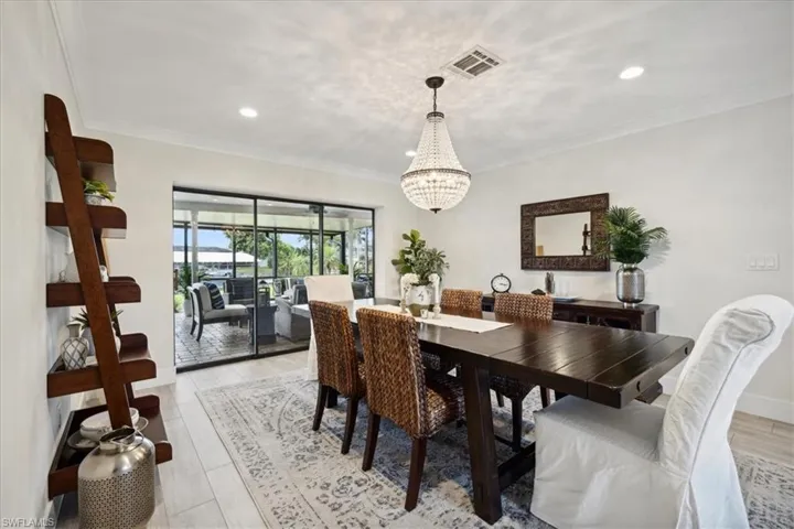Dining room with crown molding and a notable chandelier