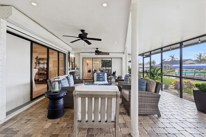 Sunroom / solarium featuring ceiling fan