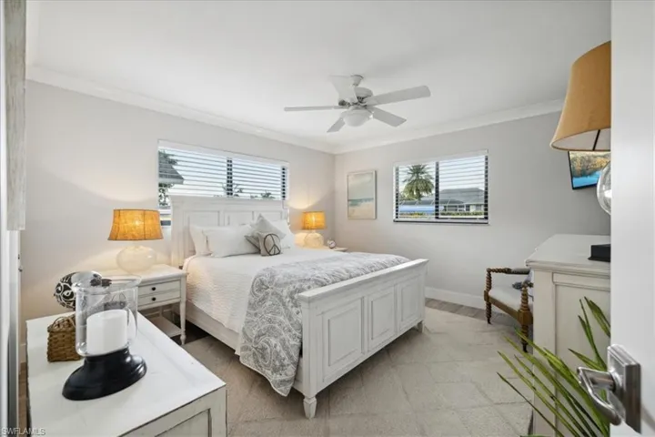 Bedroom with crown molding and ceiling fan