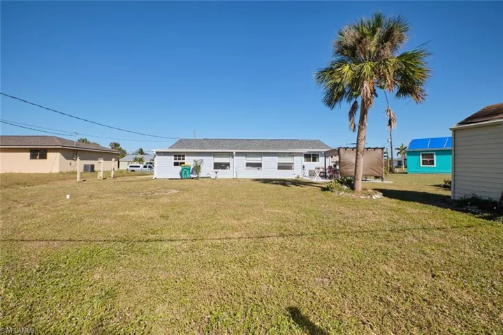 Back of house with a yard