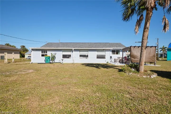 Rear view of house featuring a lawn