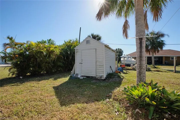 View of outbuilding with a lawn