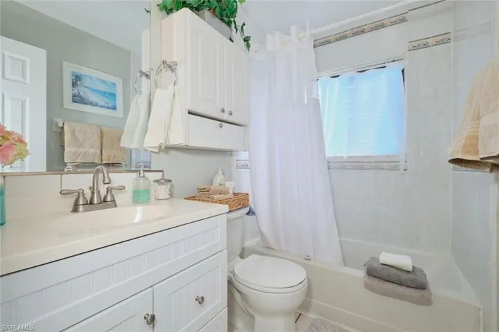 Full bathroom with vanity, toilet, and shower / tub combo with curtain