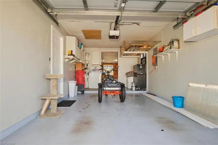 Garage with washer / clothes dryer and a garage door opener