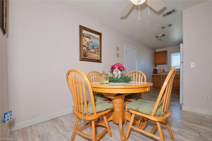 Dining space featuring ceiling fan, light hardwood / wood-style floors, and a textured ceiling