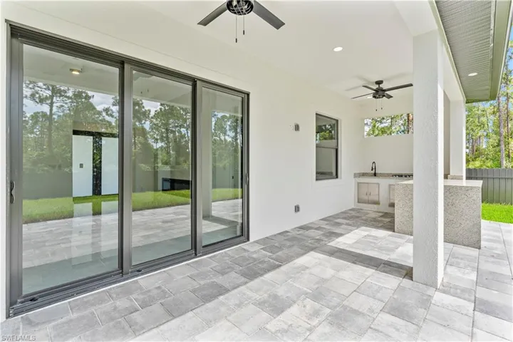 View of patio / terrace featuring exterior kitchen, ceiling fan, and sink