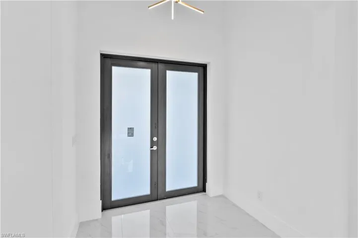 Spare room featuring french doors