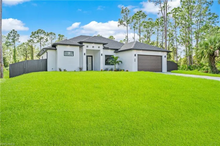 Prairie-style home with a front yard and a garage