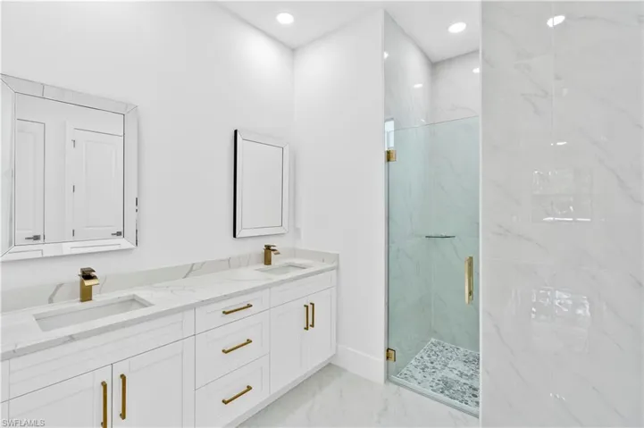 Bathroom featuring walk in shower and vanity