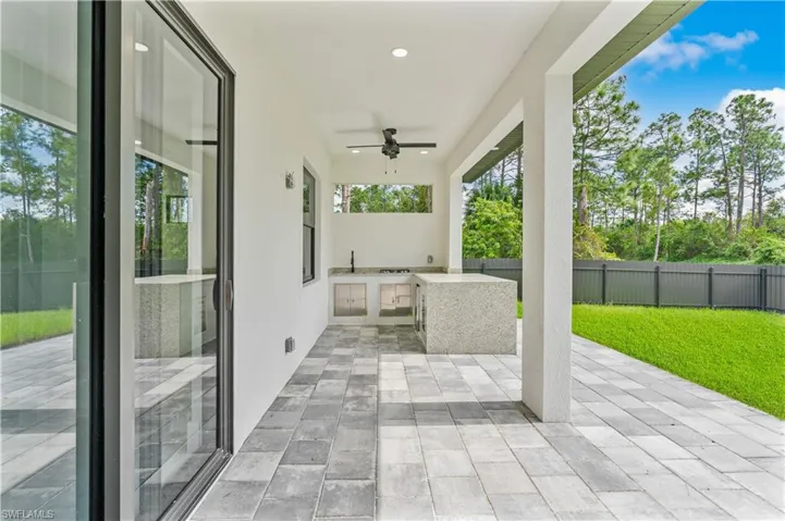 View of patio featuring exterior kitchen and ceiling fan