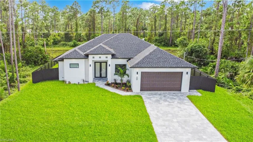 View of front of house with a front lawn and a garage