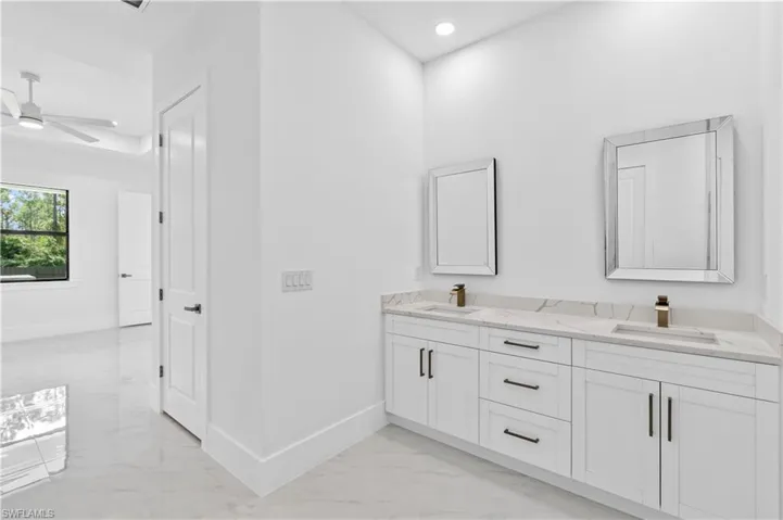 Bathroom featuring ceiling fan and vanity