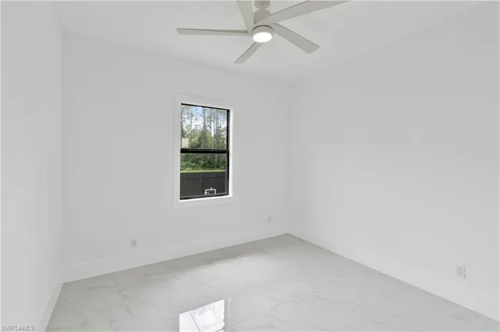 Spare room with ceiling fan