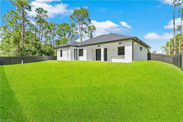 Rear view of house with a lawn