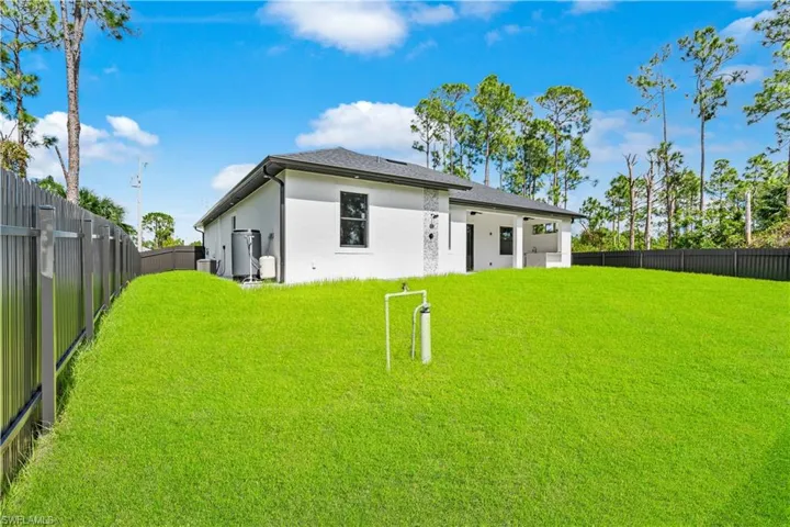 Back of property featuring a yard