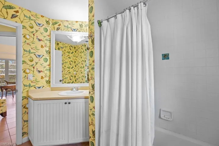 Bathroom featuring shower / tub combo and vanity
