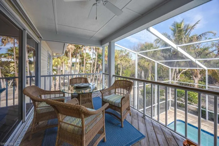 Sunroom featuring ceiling fan