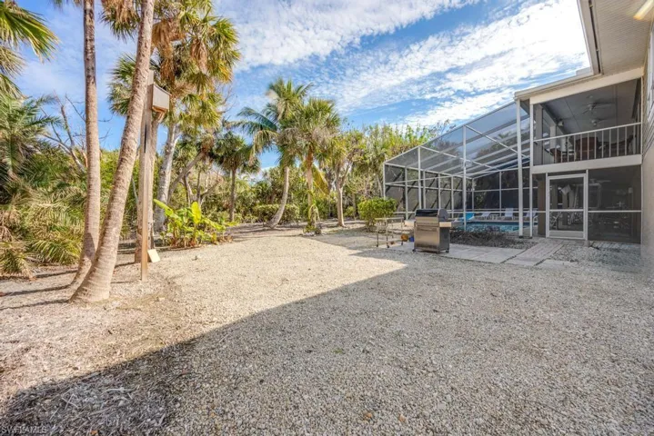 View of yard with glass enclosure, a patio area, and a swimming pool