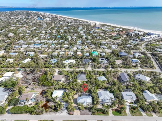 Bird's eye view featuring a water view and a view of the beach
