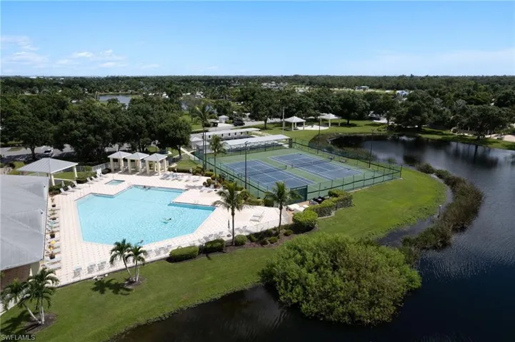 Aerial view of a pool area and a large body of water