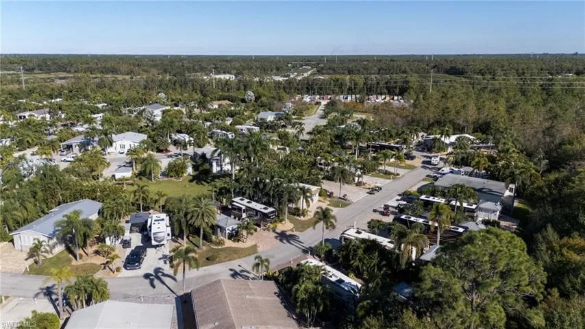 Aerial view of property and surrounding area featuring nearby suburban area