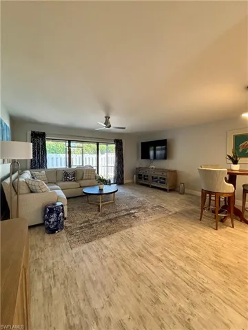 Living room featuring wood finished floors and a ceiling fan