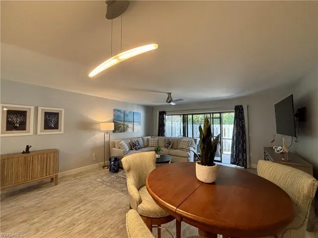 Dining room featuring a ceiling fan and light wood-style flooring