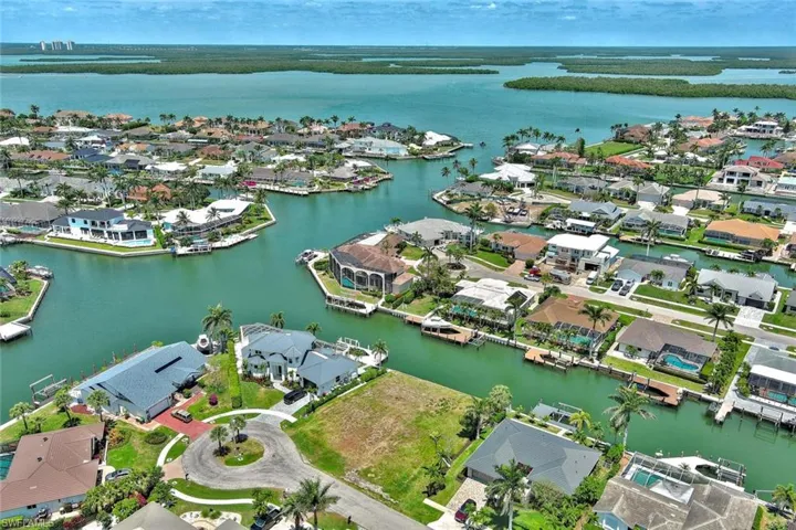 Birds eye view of property with a water view and a residential view