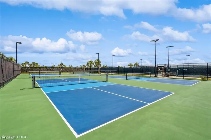 View of tennis court with community basketball court