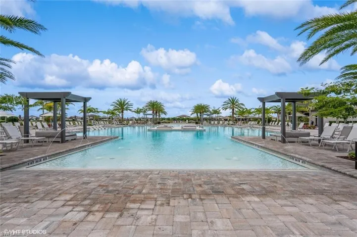 Community pool with a patio area and a gazebo