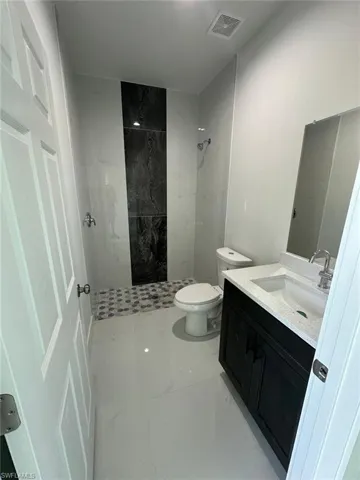 Bathroom with vanity and a shower stall