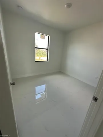 Spare room featuring baseboards