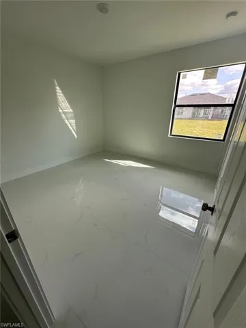Empty room with baseboards and light marble finish flooring