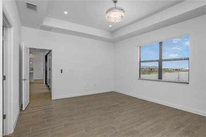 Owner bedroom, located at the rear of the home, overlooks the beautiful lake view.