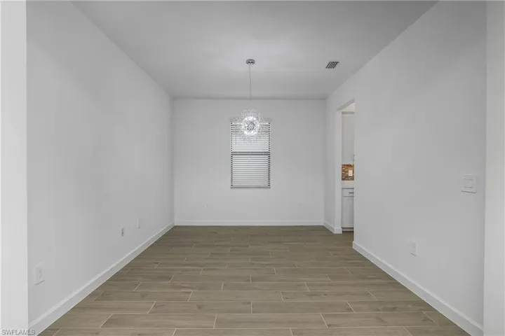 This versatile space can be used as a large den/office, or as a formal dining area.