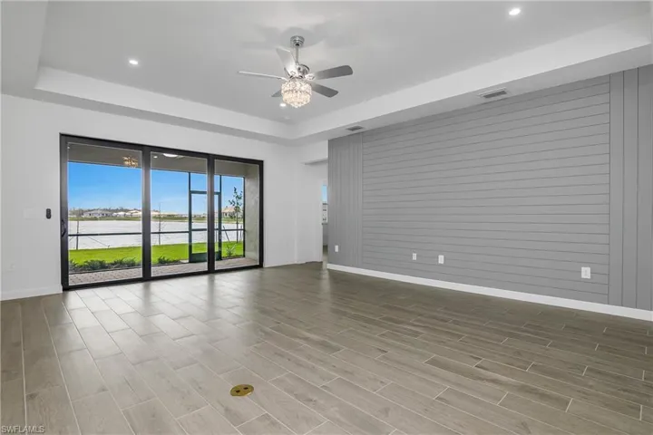 This great room is perfect for gathering with family and friends and offers additional after-market recessed lighting, ceiling fan/chandelier, custom feature wall, lots of natural light, and a FABULOUS view!