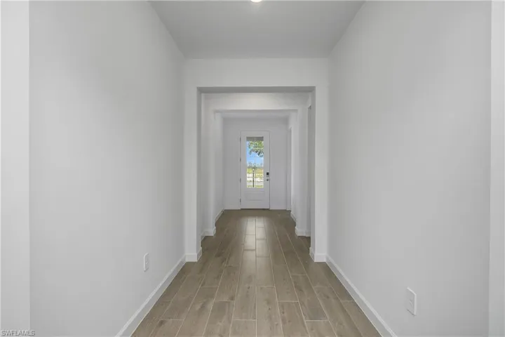 Welcoming Foyer/Entryway. Greet your guests in this elegant entryway featuring a glass front door and plank tile flooring throughout home.